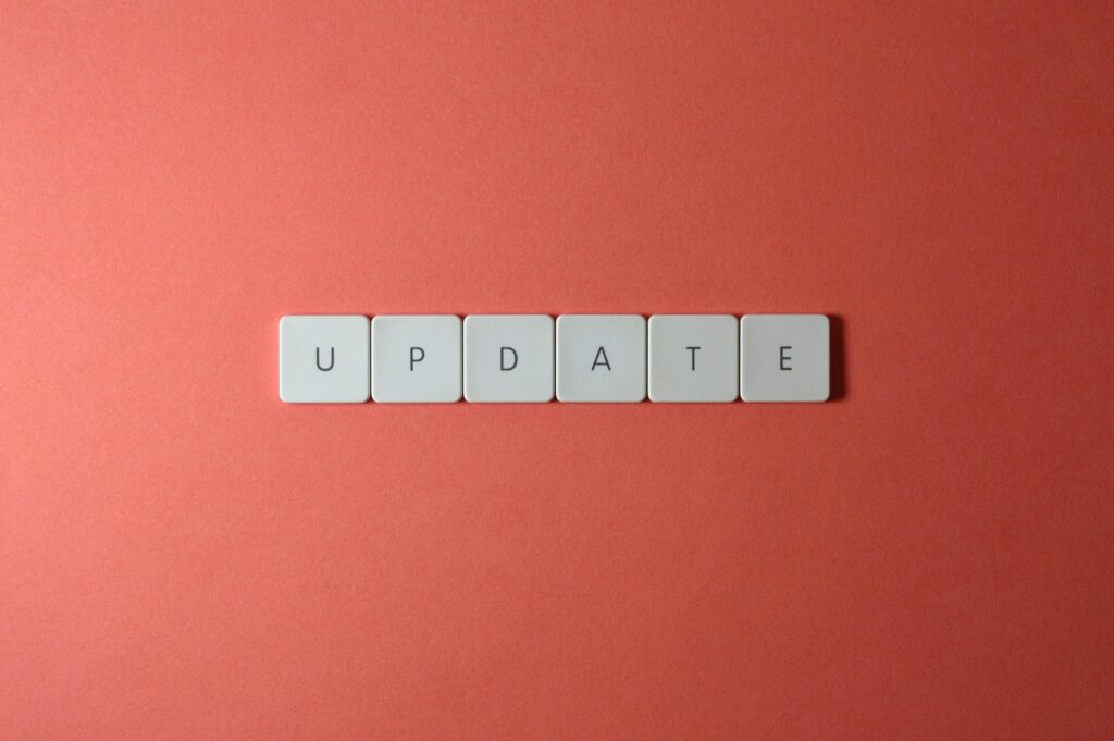 Keyboard keys arranged to spell 'update' on a vibrant red background, ideal for conveying tech concepts.
